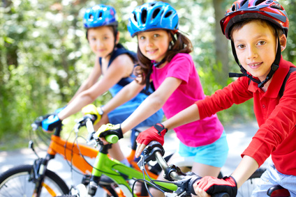 Three little children riding their bikes